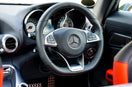 Close-up of a Mercedes-Benz AMG steering wheel displaying the "SRS Airbag" label, dashboard controls, and luxurious black and red interior. A visual reminder of the importance of vehicle airbags in modern car safety.