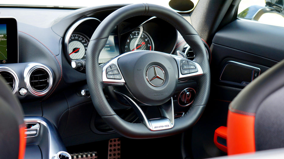 Close-up of a Mercedes-Benz AMG steering wheel displaying the 